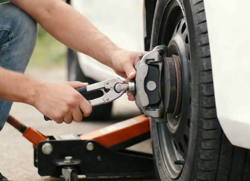 Reinstall caliper and wheels, then lower the car